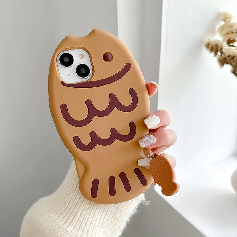 Brown silicone phone case with 3D taiyaki design and hanging ornament for iPhone.