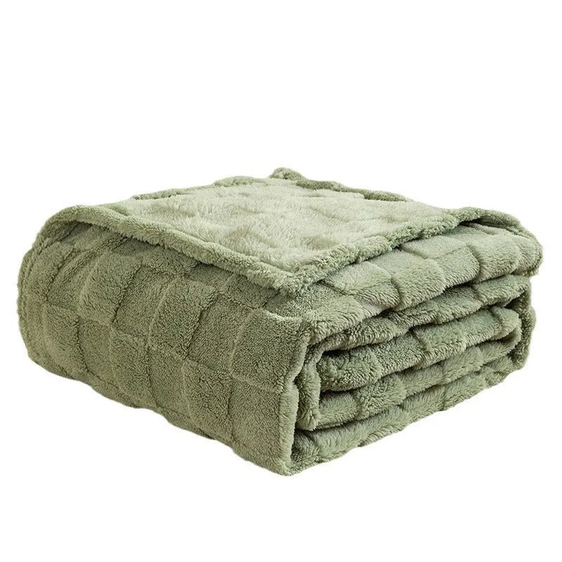 Geometric pattern polyester velvet blanket in dark grey, shown draped over a sofa.