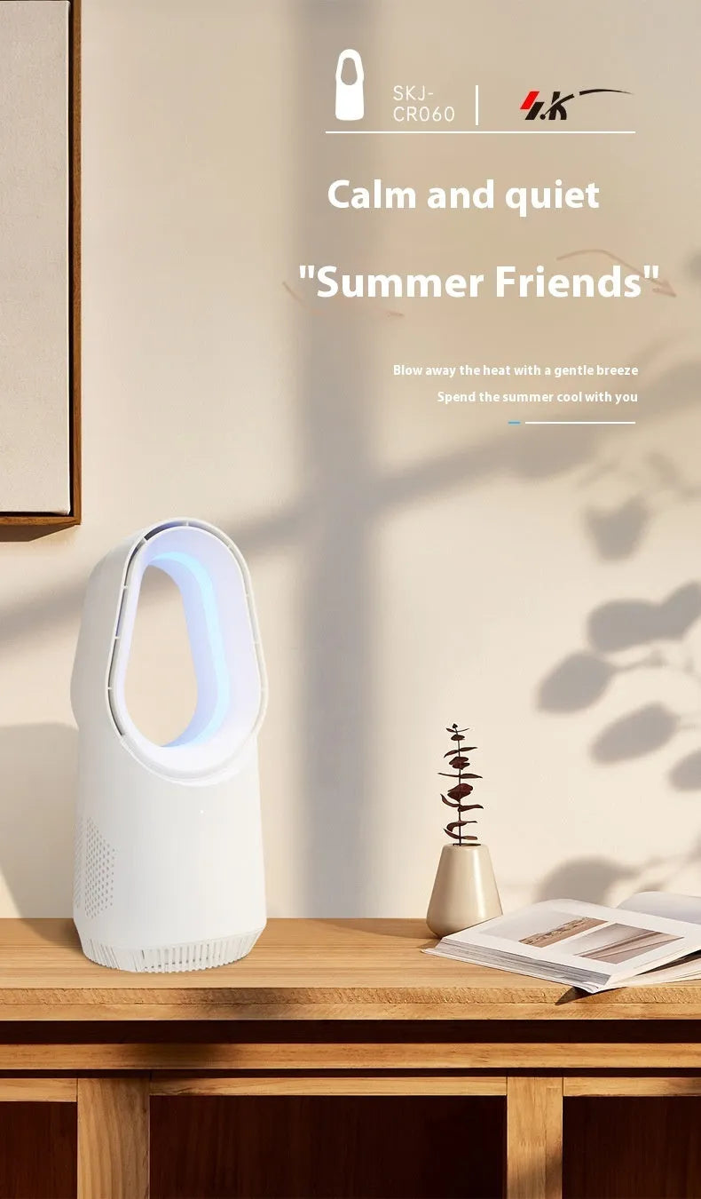 A white bladeless tower fan with a remote control on a wooden floor next to a desk.
