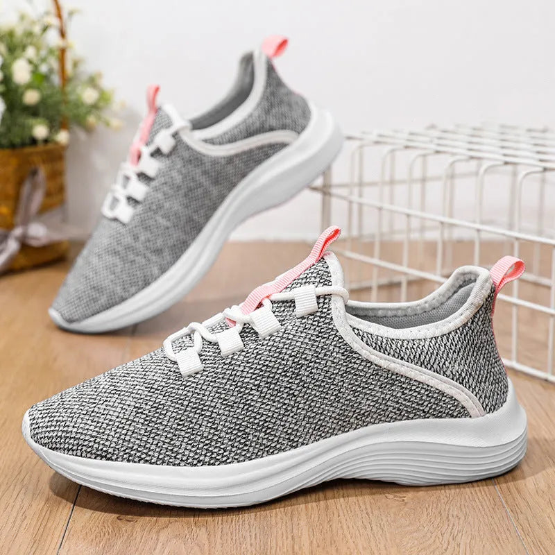 Women's low-top casual sneakers with flyknit mesh upper in black, pink, or grey.