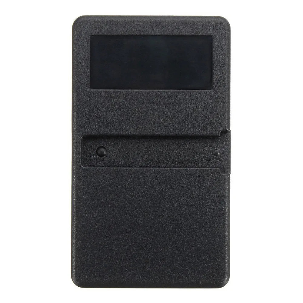 Black plastic three-button garage door remote control next to a CR2032 battery.