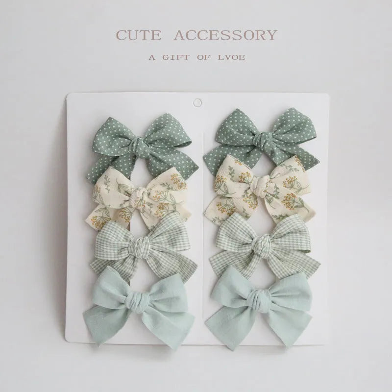 Children's cloth bow hairclip set showing dovetail shape in multiple colour options