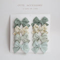 Children's cloth bow hairclip set showing dovetail shape in multiple colour options