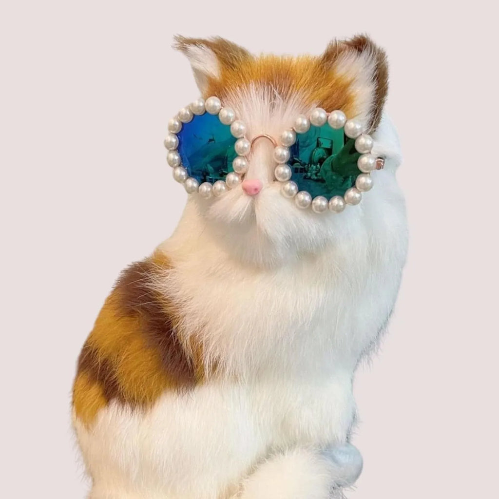 Pearl-rimmed round sunglasses for a cat or dog, shown in blue, with size options of 11cm and 8cm.
