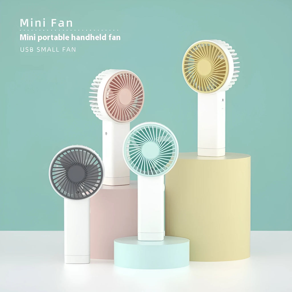 Outdoor portable USB rechargeable handheld fan in pink with three plastic blades and single speed button