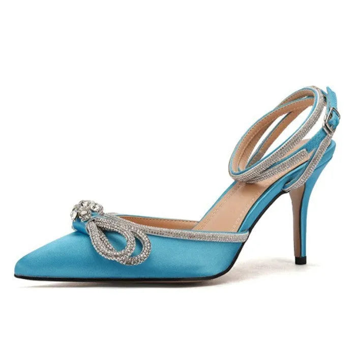 Women's black stiletto sandals with silk-like bandage across heel and gold buckle closure.