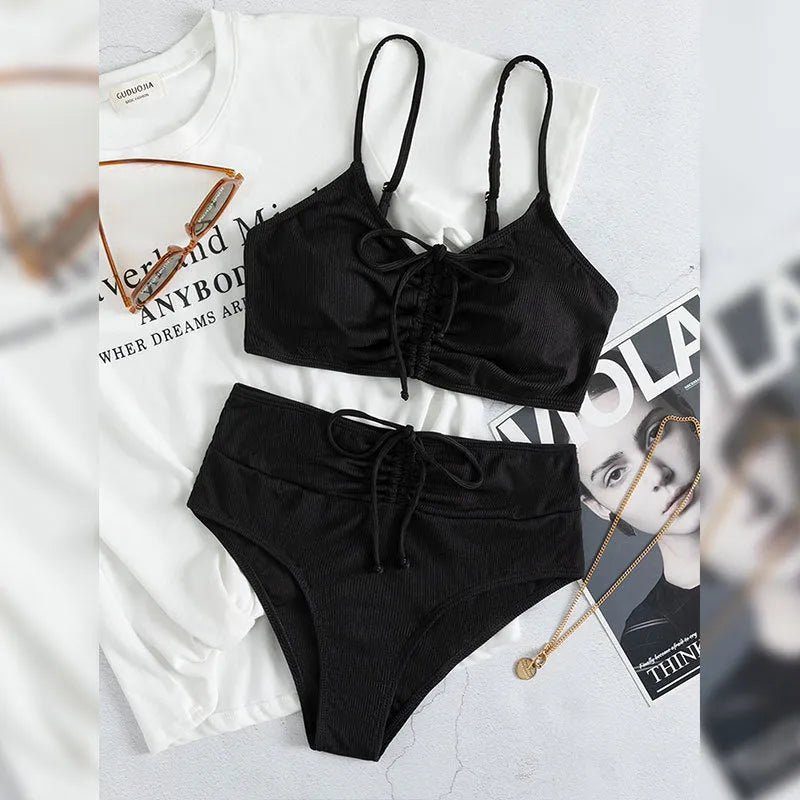 Black women's swimsuit with high waist bottoms and sleeveless top on mannequin