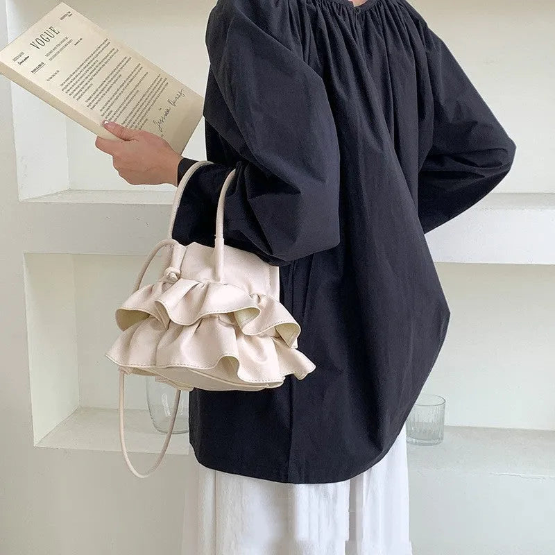 Ruffled bucket-style shoulder bag in Beige with open outer pocket and folding design