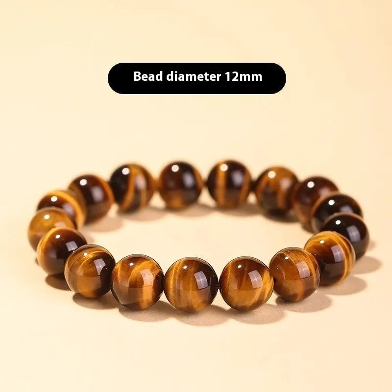 Ethnic style single circle bracelet with a patterned Tigereye Dzi bead on wrist.
