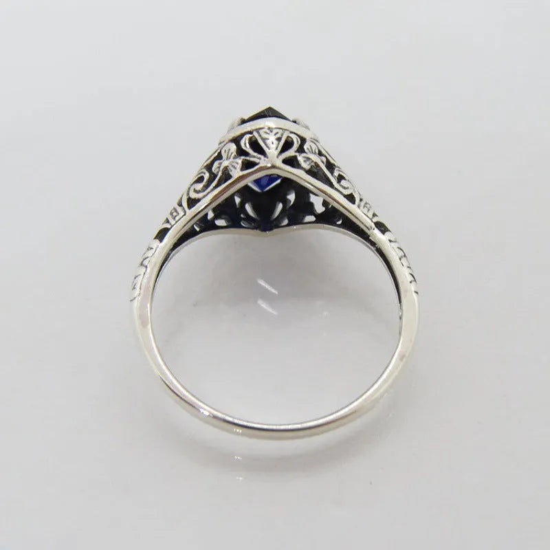 Women's silver geometric hollow ring showing alloy construction and patterned design