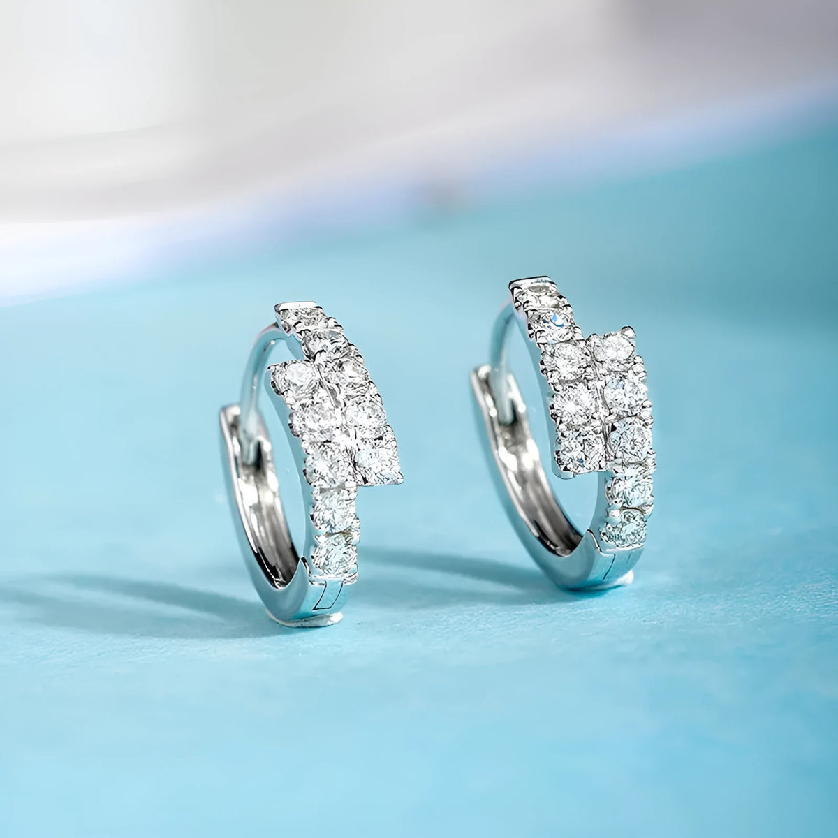 Small diamond ear clip earrings in white gold colour copper with geometric ring design, one pair