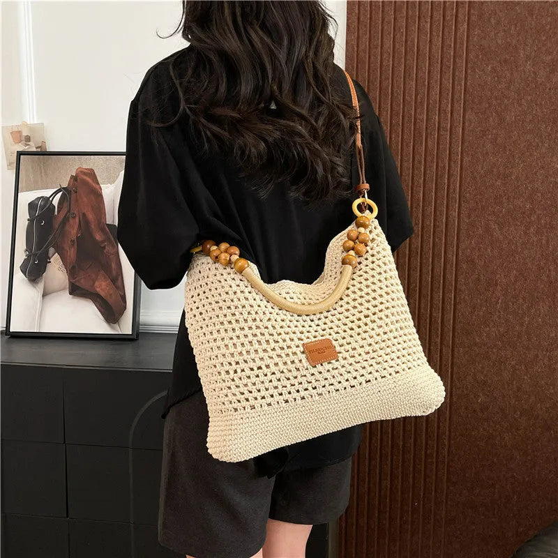 Large knitted beach tote bucket bag in black or brown with zipper compartment and contrasting stitching