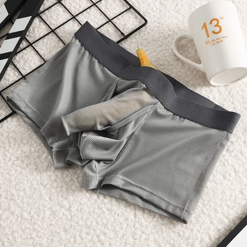 Men's black Ice Silk mesh boxer shorts laid flat, showing low-rise waistband and breathable fabric texture.