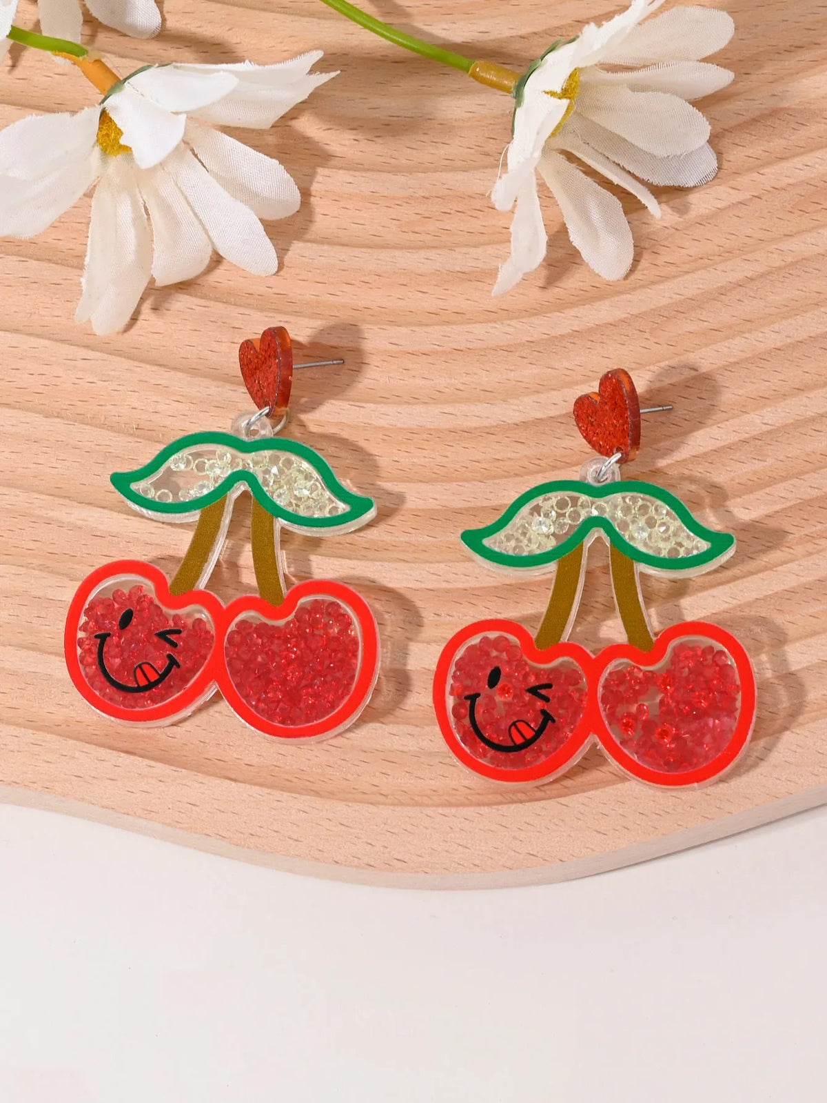 Set of acrylic earrings shaped like cherry, strawberry, watermelon, pineapple, coconut, cake, and ice cream.