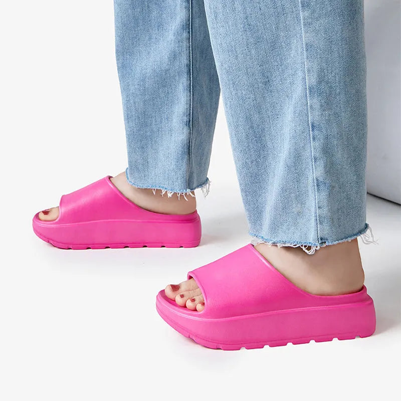 Women's beige EVA fish mouth slippers with a thick 5.5cm sole on a tiled floor.