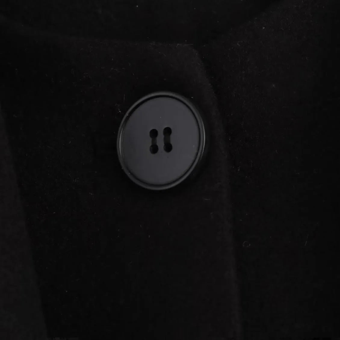Women's long grey coat with an artificial fur collar, shown with pockets and a street fashion style.