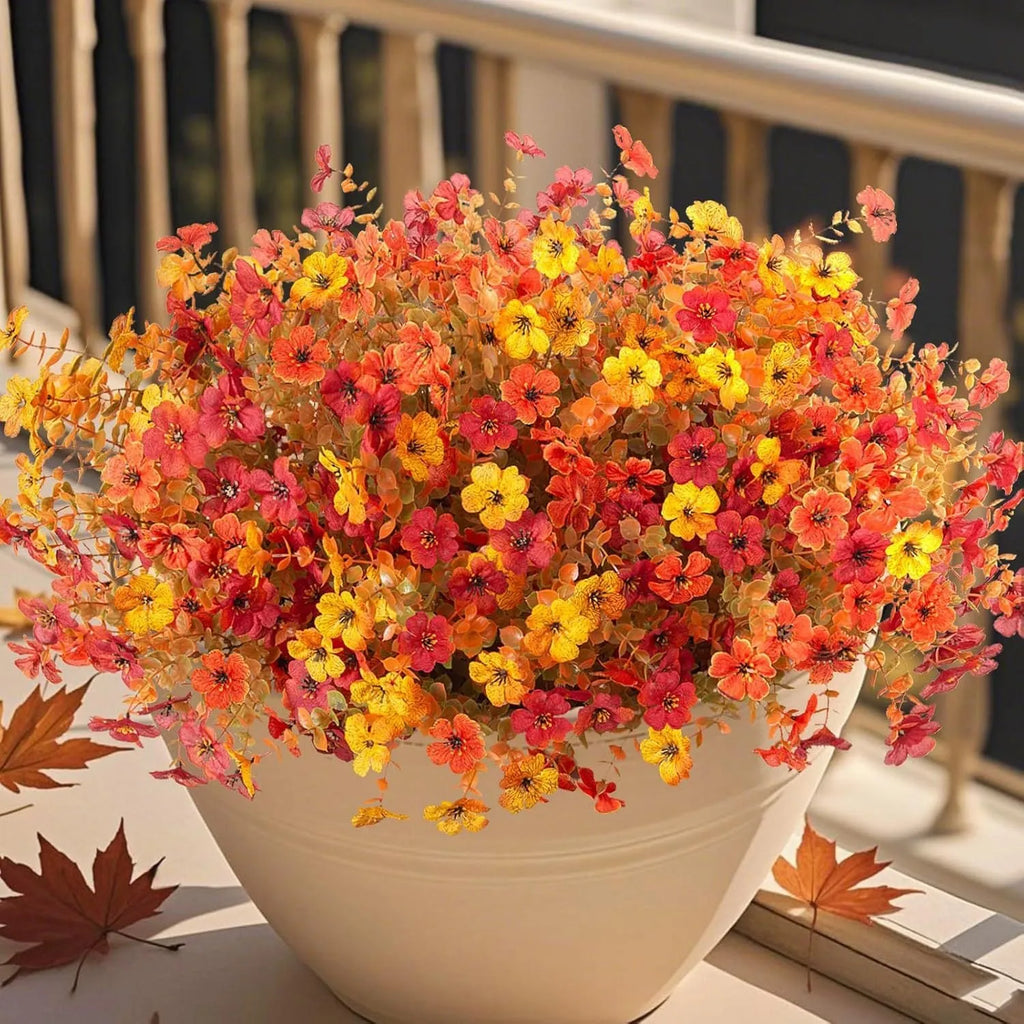 Plastic and silk artificial flower bouquet in autumn red, yellow, orange, and orange-yellow colours for home and event decor.
