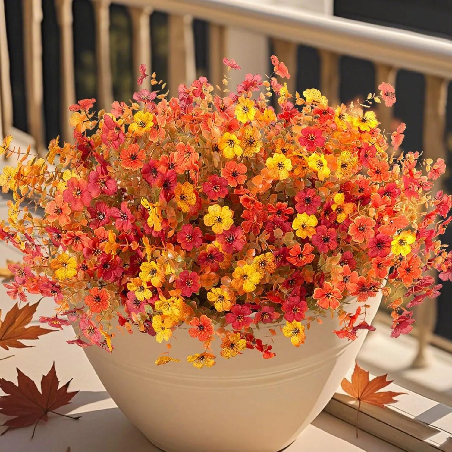 Plastic and silk artificial flower bouquet in autumn red, yellow, orange, and orange-yellow colours for home and event decor.