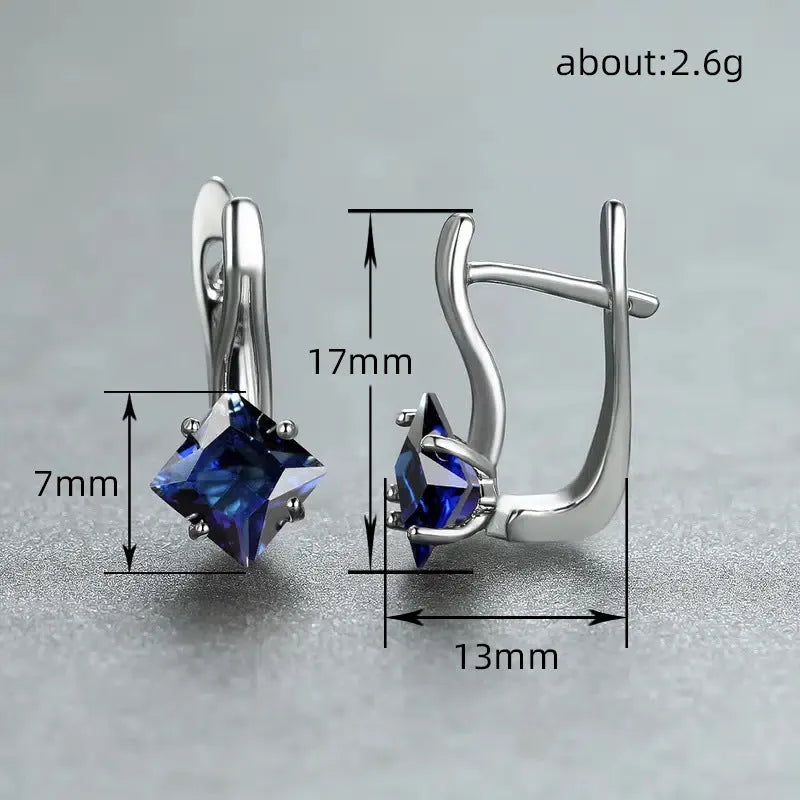 A pair of copper diamond design earrings for women with inlaid zircon stones, shown in blue, green, and a metallic colour.