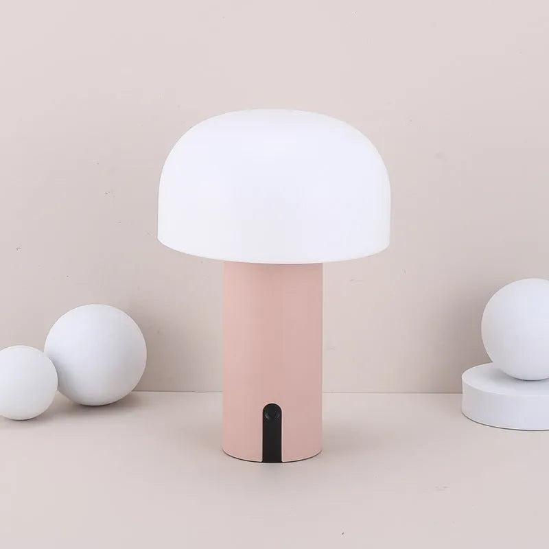 Decorative LED mushroom night light in green with warm white glow on a bedside table