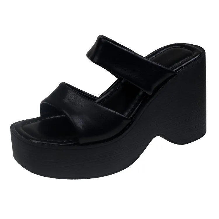 Women's black wedge platform slippers with square toe design on grey background