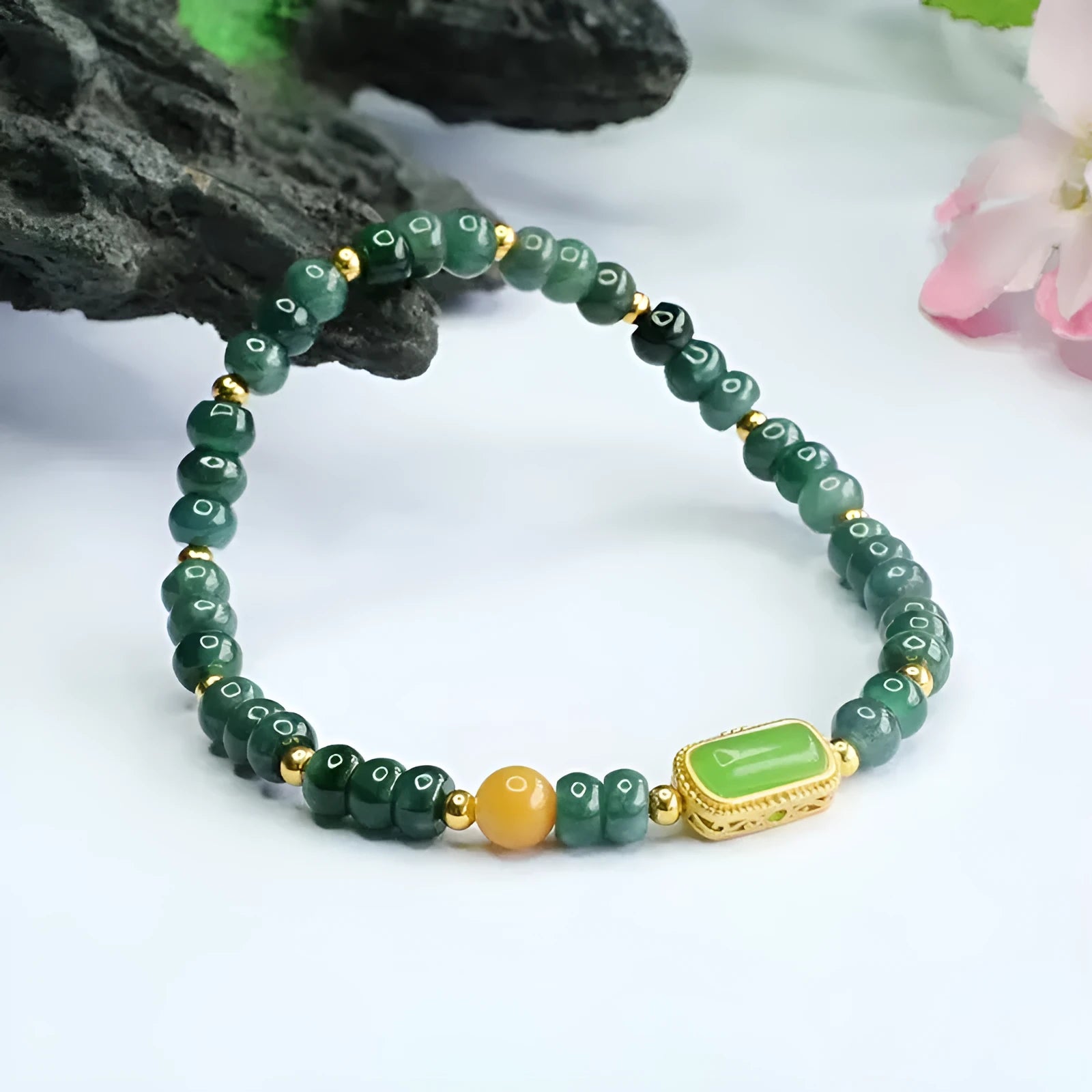 Natural stone blue water jade beaded bracelet with round and oval geometric beads on a white background
