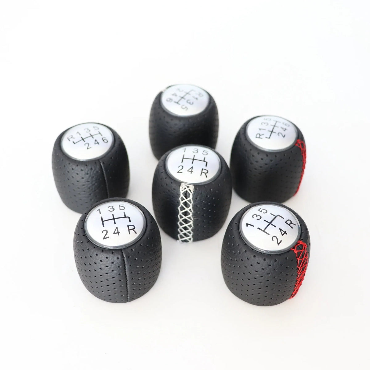 Sewn wrapped perforated leather gear handball for Toyota Alpha in matte and silver finishes.