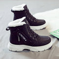 Plus size women's snow boot in black with velvet lining, showing mid-calf height and front lace-up.