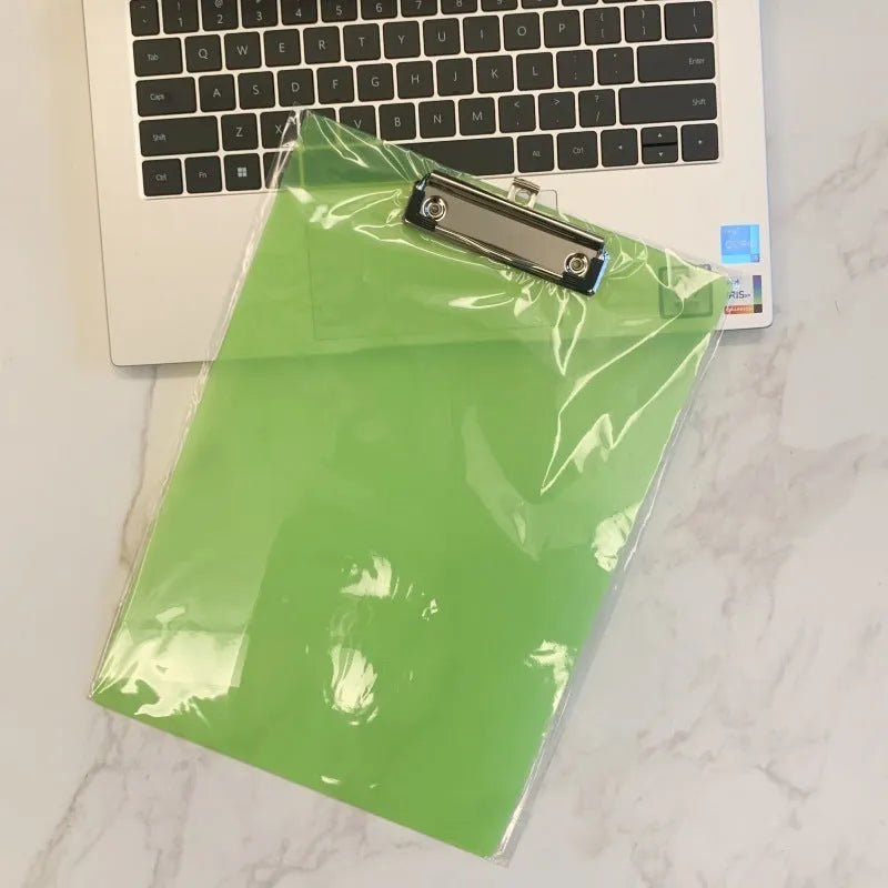 A4 transparent plate holder writing board with metal clip, shown in blue on a desk.