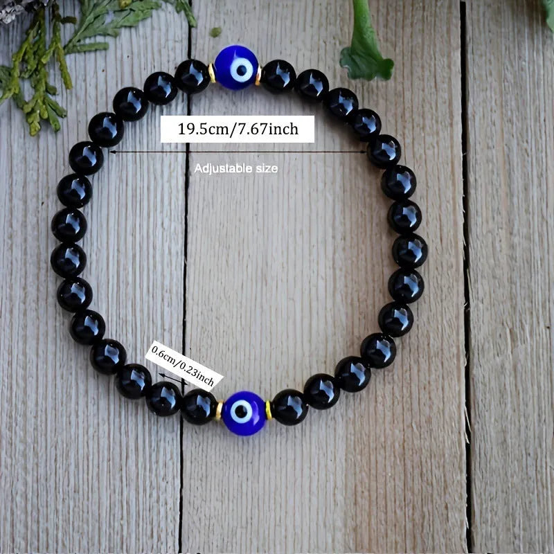 Men's black beaded bracelet with 8mm devil's eye beads and 6mm black beads in a geometric design.