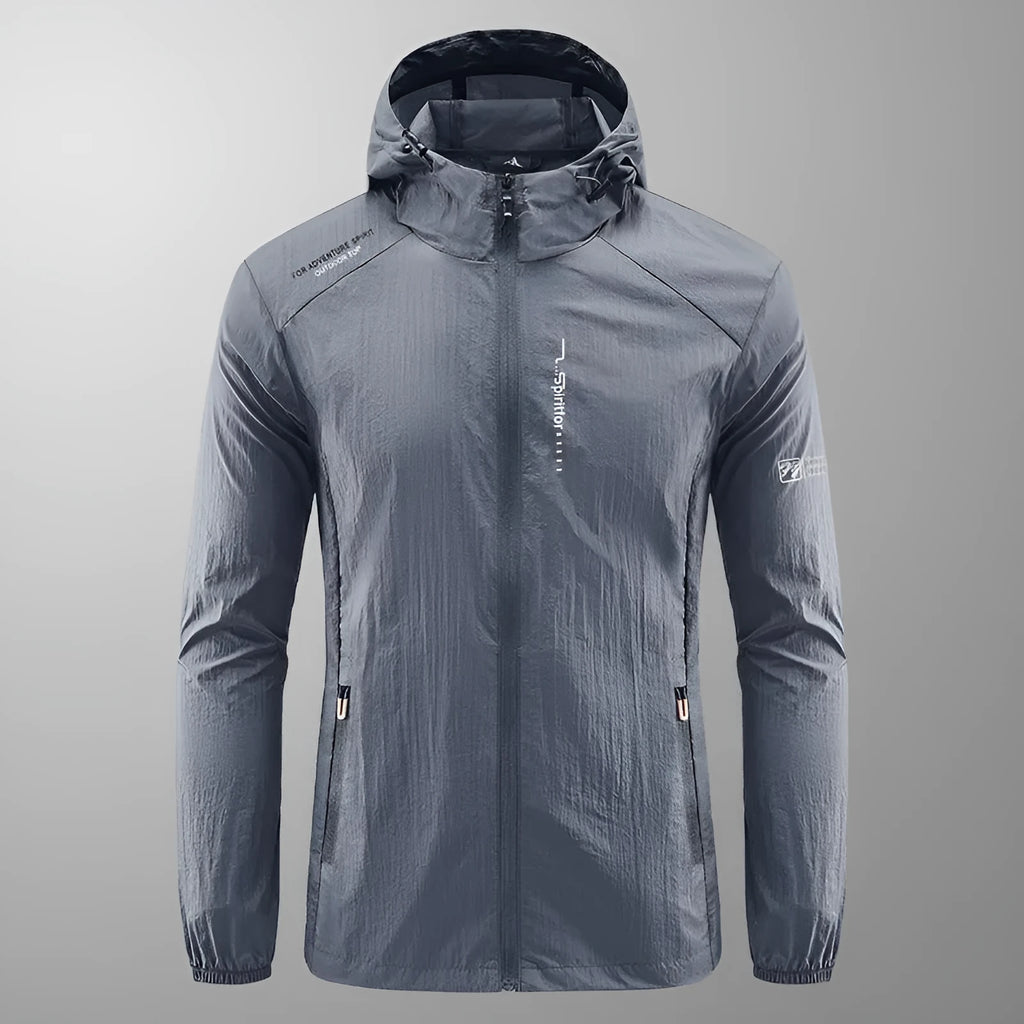 Man wearing a lightweight light grey hooded summer jacket made of thin nylon.