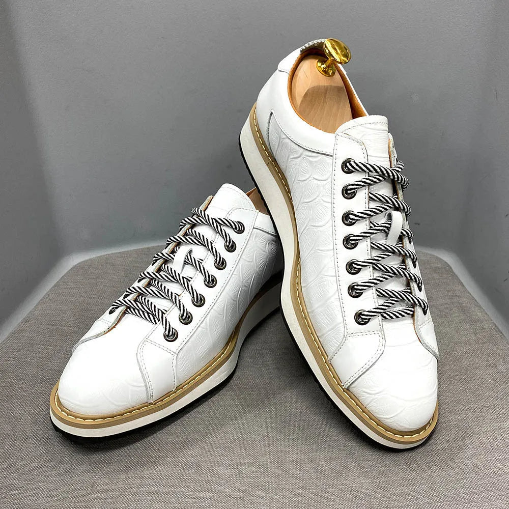 Men's handmade embossed pattern shoes in low tube design with front tie closure showing detail of pattern work