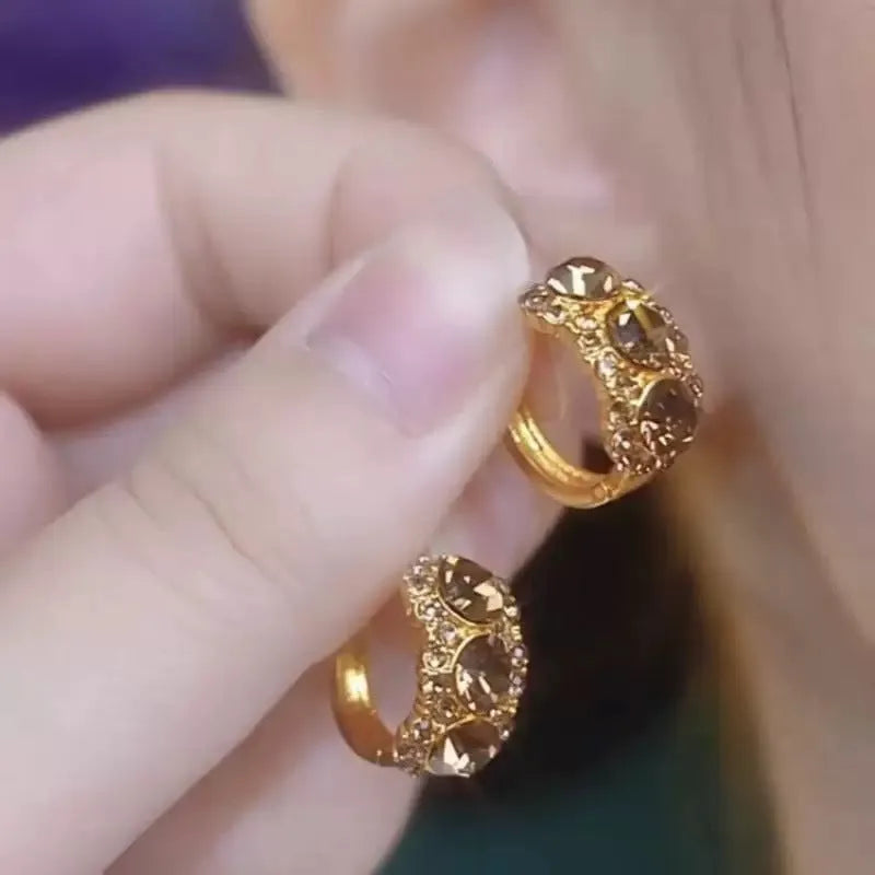 Gold metal hoop earrings with brown zircon stones in geometric shape