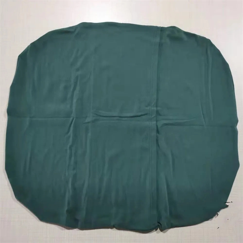Beige portable cotton baby nest crib for newborns on a neutral background
