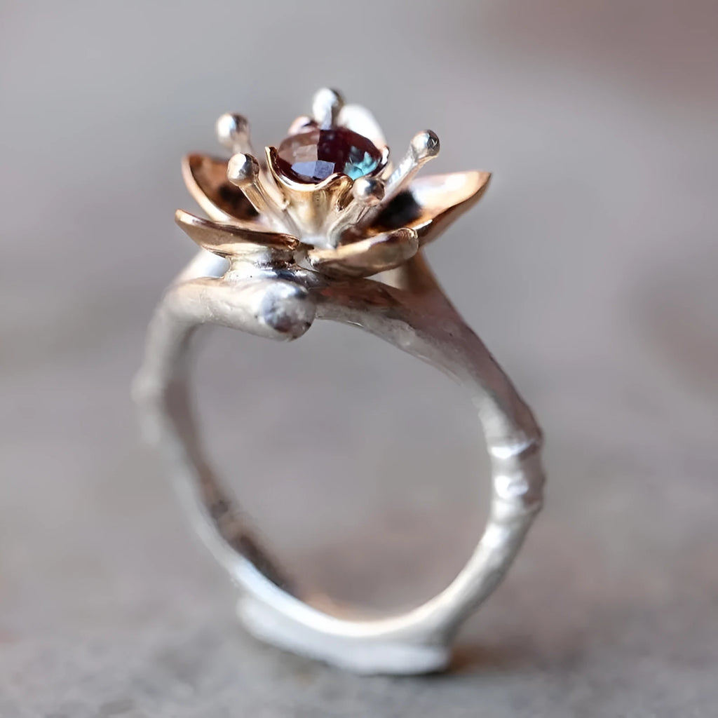 Silver two-tone floral design women's alloy ring on a geometric band.