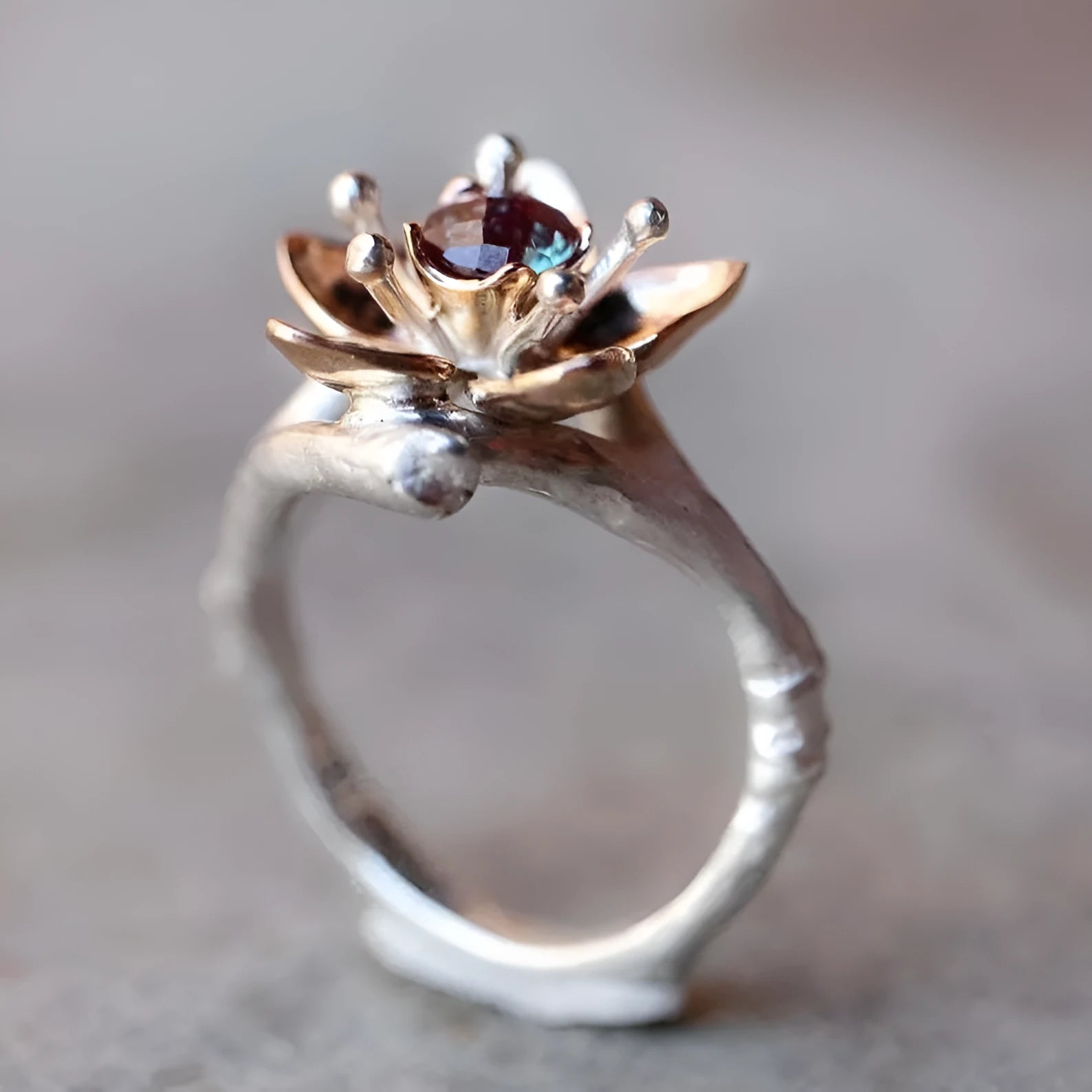 Silver two-tone floral design women's alloy ring on a geometric band.