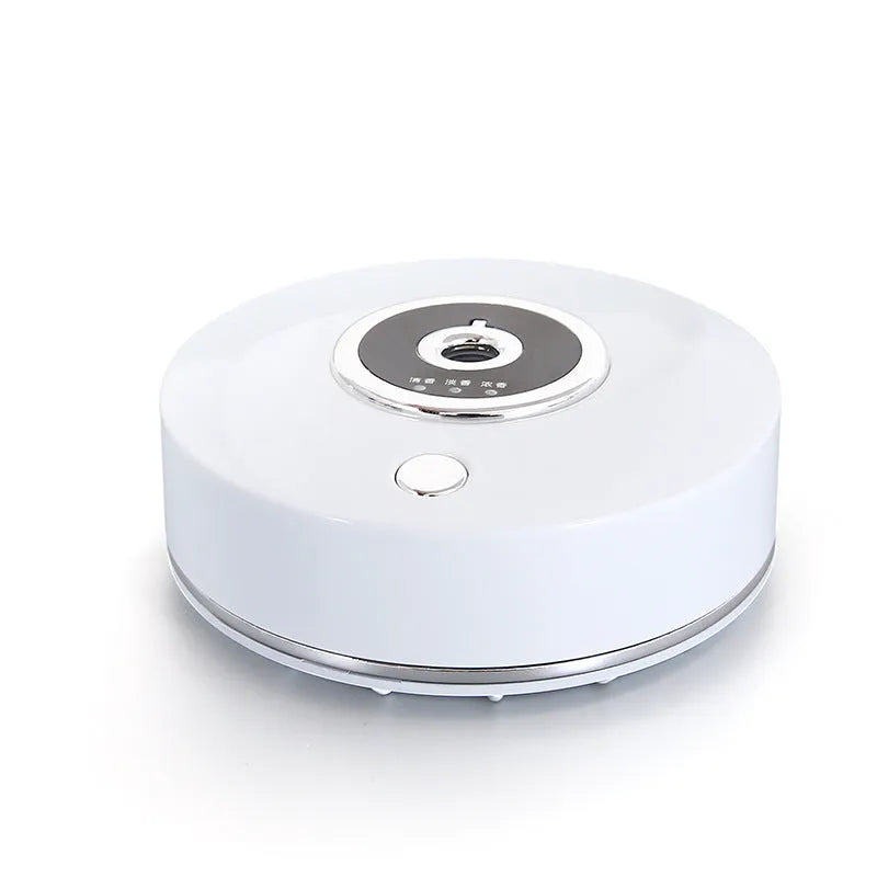 White plastic USB-powered car fragrance spray holder attached to a vehicle air vent.