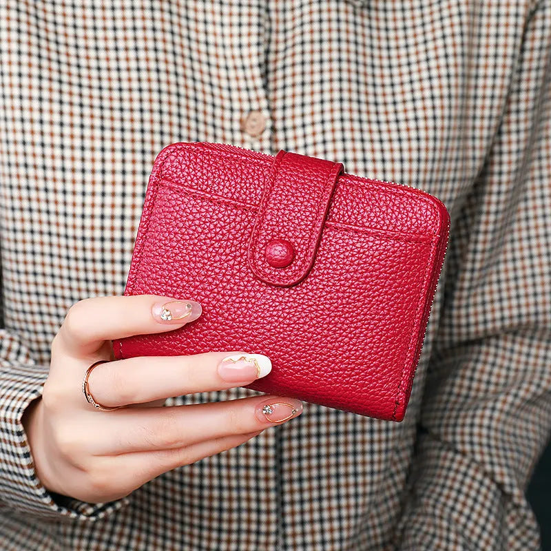 Women's solid colour short wallet with lychee pattern and sewing thread detail in multiple colours.