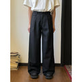 Men's brown straight-leg casual trousers with a loose, wide-leg fit on a neutral background.