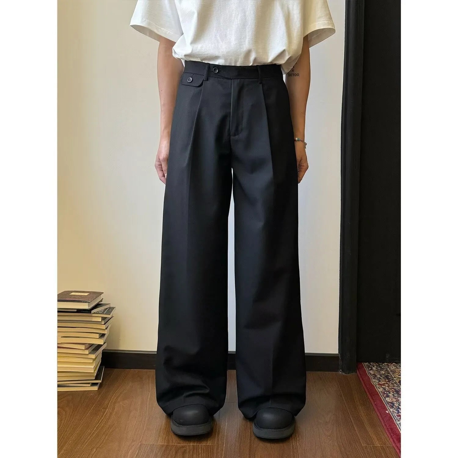 Men's brown straight-leg casual trousers with a loose, wide-leg fit on a neutral background.