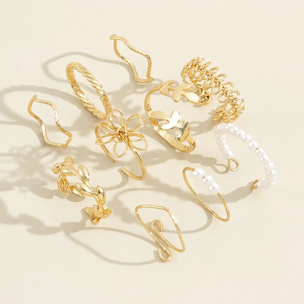 Gold coloured openwork floral design alloy ring set for women, showing glossy electroplated finish.