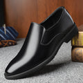 Men's black leather business casual slip-on shoes with rubber sole and sewing line detail.