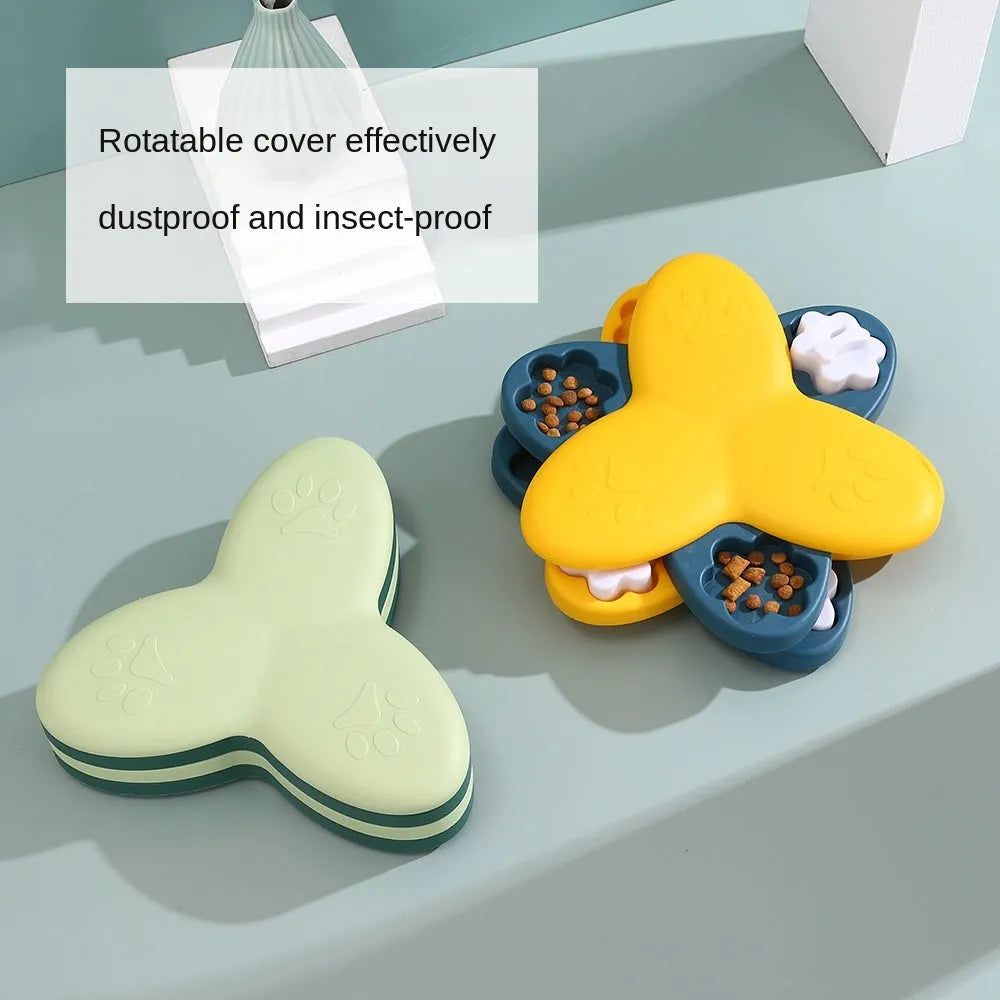 Green and yellow dog puzzle toy with bone covers and rotatable treat dispenser on non-slip base