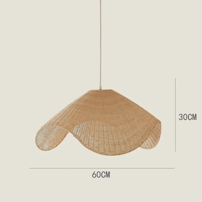 Handmade natural rattan and willow bamboo chandelier with warm LED light in a rustic setting.