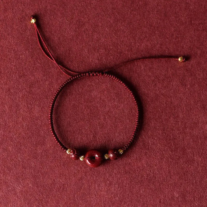 Cinnabar safety buckle bracelet with heart-shaped beads on adjustable rope cord in traditional birth year design