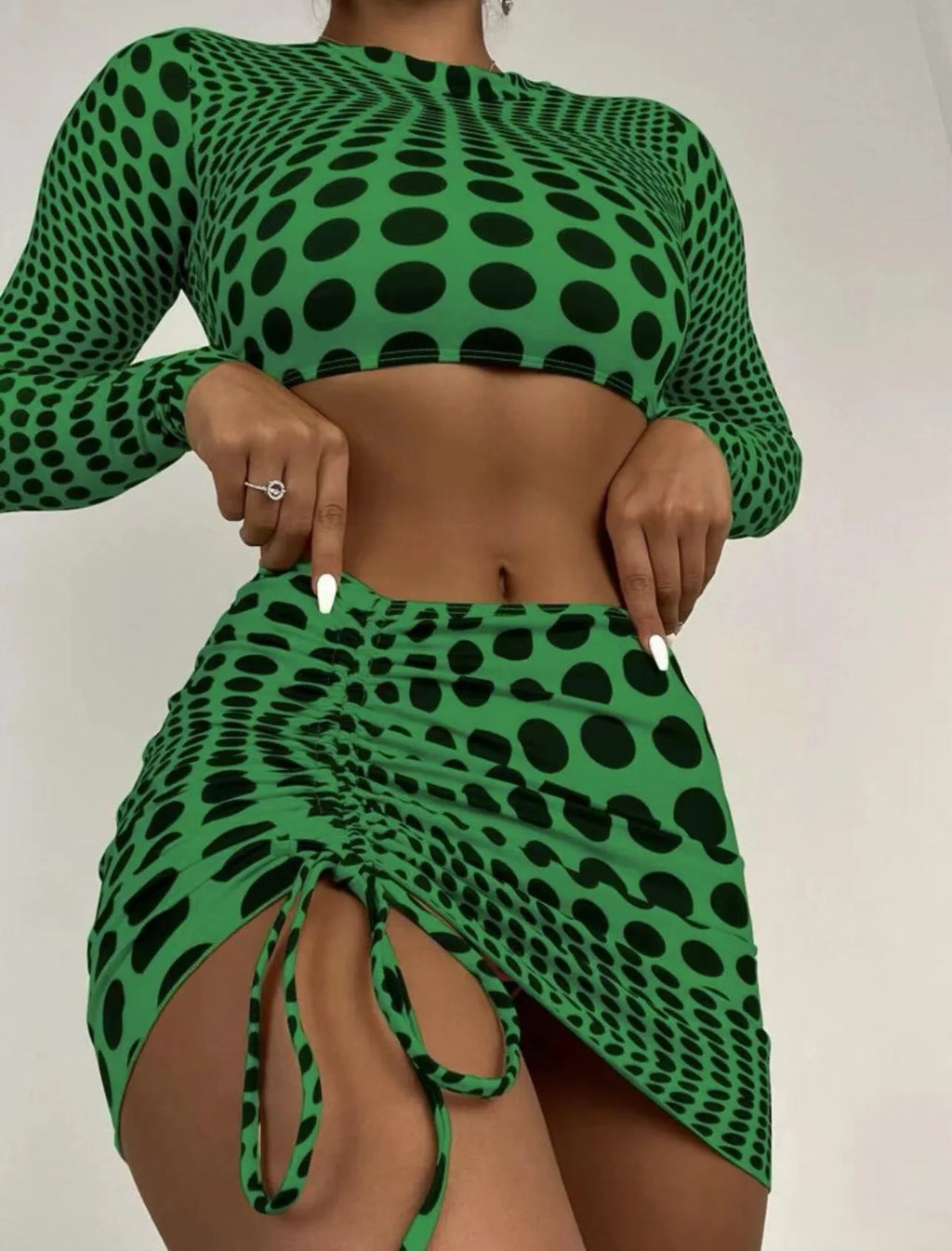 Women's green polka dot swimsuit three-piece set showing top, skirt, and bra