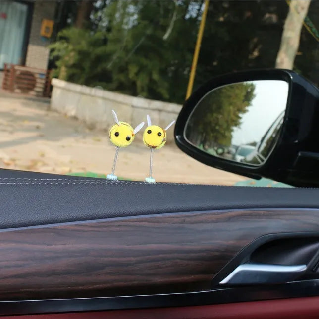 Small yellow and black fur ball bee car decoration ornament measuring 3cm.