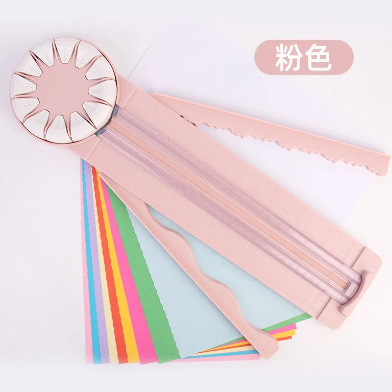 Pink plastic paper cutting machine with dotted alignment guides and 12 cutting patterns
