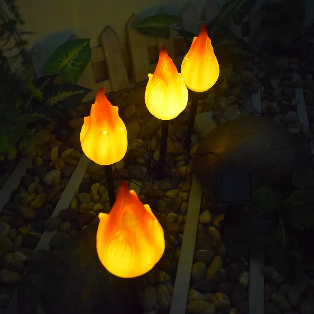 Solar simulation flame lamp with wrought iron frame and yellow flame effect in garden courtyard
