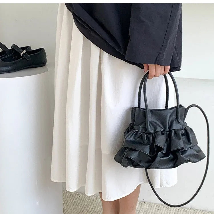 Ruffled bucket-style shoulder bag in Beige with open outer pocket and folding design